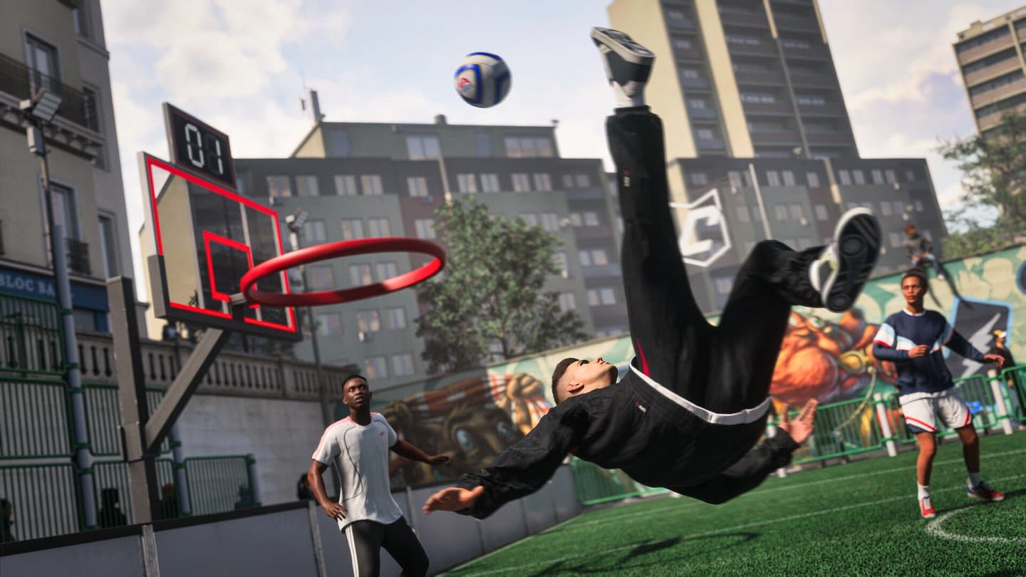 A player in black does a bicycle kick on a walled street pitch between apartment blocks, next to a basketball hoop.
